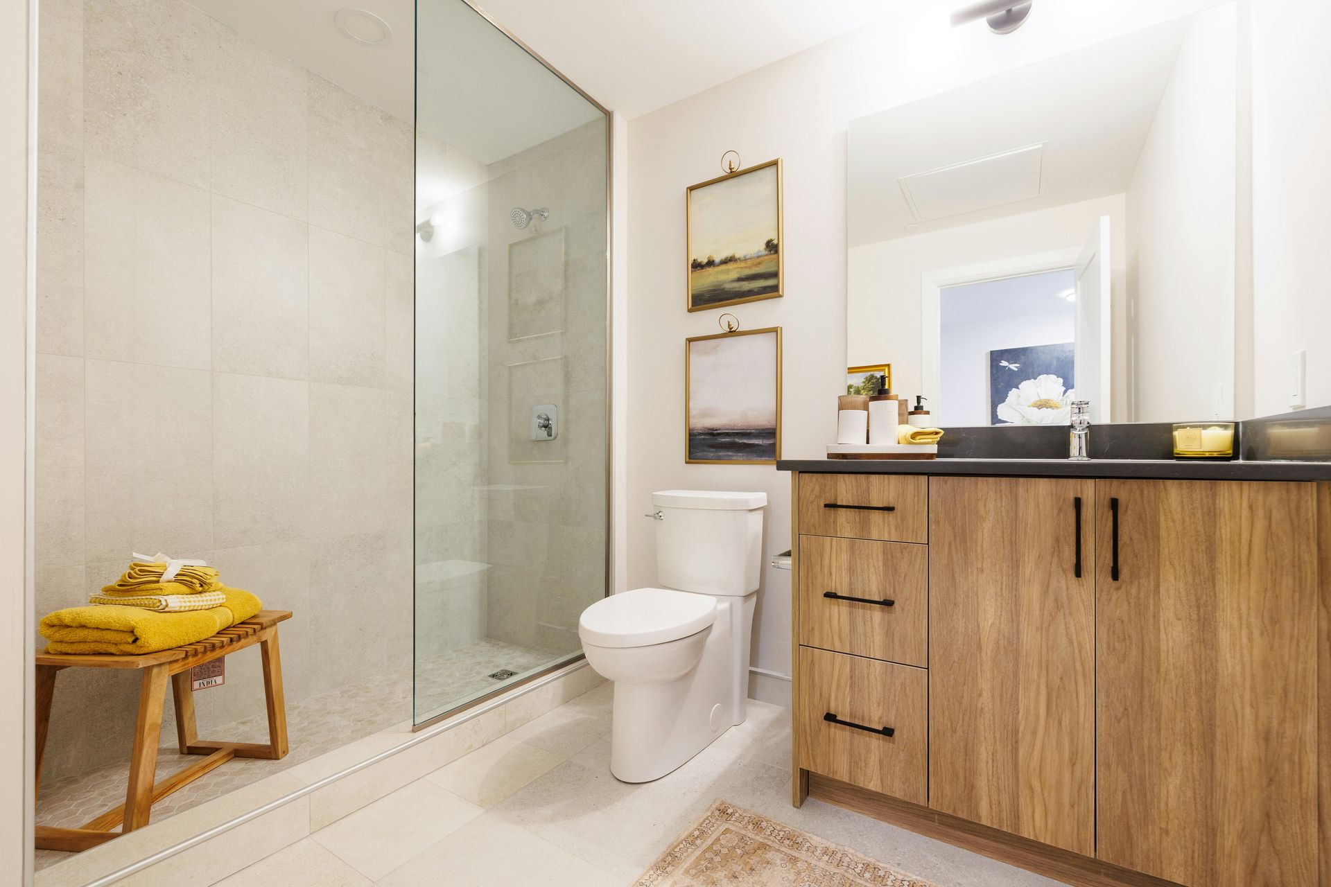 Modern bathroom with wooden vanity and glass shower